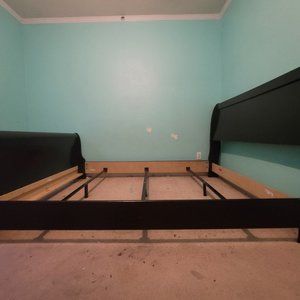 A black Queen size slay bed